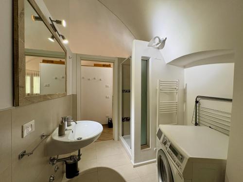 a bathroom with a sink and a mirror and a tub at The vault of the village, 200 meters from the center and the lake in Lovere