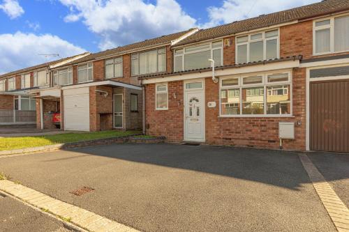 an empty parking lot in front of a brick building at Spacious 4 Bed House in Exhall, Sleeps 7 in Exhall