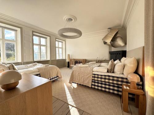 a large room with two beds and a couch at Luxury 260 sqm with 4BR overlooking Kings Garden in Copenhagen
