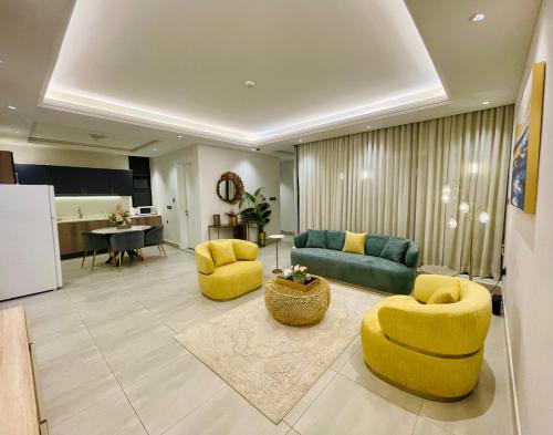 a living room with yellow chairs and a couch at Spacious new 2 bedroom Apt-in amazing location B9 in Riyadh