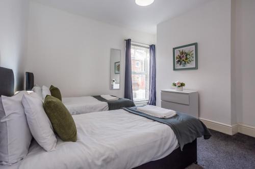 a hotel room with two beds and a window at St Pauls Terrace in Ryhope