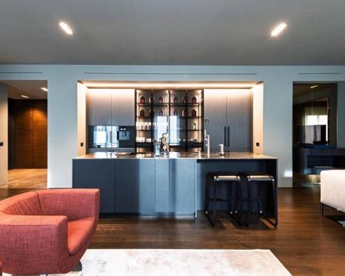 a kitchen with a island in a living room at Karl Penthouse in Rostock