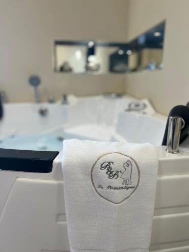 a white towel sitting on a kitchen sink at La Romantique Rooms and Apartments TROPEA in Parghelia