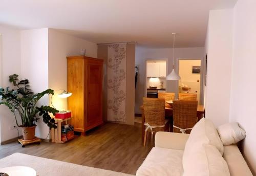 a living room with a couch and a dining room at Ferienwohnung Im Laubgarten in Öhningen