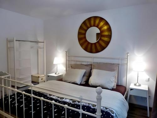 a bedroom with a bed with a mirror on the wall at Ferienwohnung Im Laubgarten in Öhningen