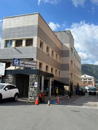a large building with orange cones in front of it at Pensión Agarimo in Trapagaran