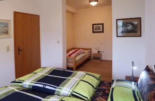 a bedroom with a bed and a room with a bed sqor at nette Ferienwohnung mit eigenem Eingang und Sonnenterrasse in Idstein