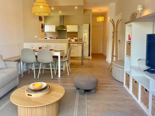 a living room with a couch and a table at T2, 50 m beach, balcony with sea view in La Teste-de-Buch