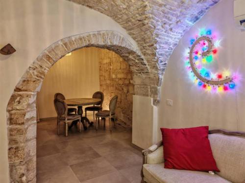 ein Wohnzimmer mit Tisch und Couch in der Unterkunft Old Town Suite Martina in Martina Franca
