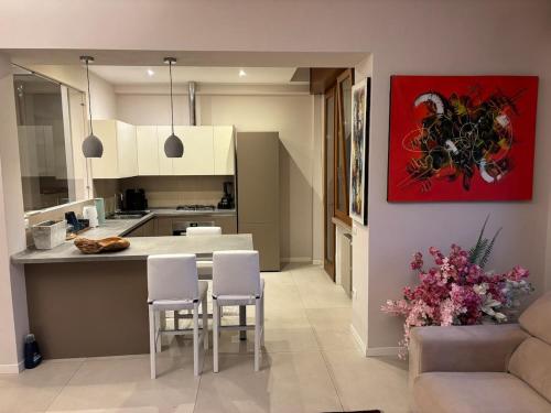 a kitchen and living room with a table and chairs at Holiday Home Parma in Parma