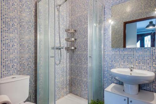 a bathroom with a toilet and a sink and a shower at AC House in Porto