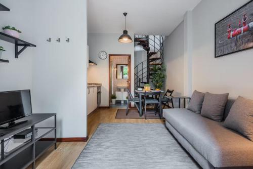 a living room with a couch and a table at AC House in Porto