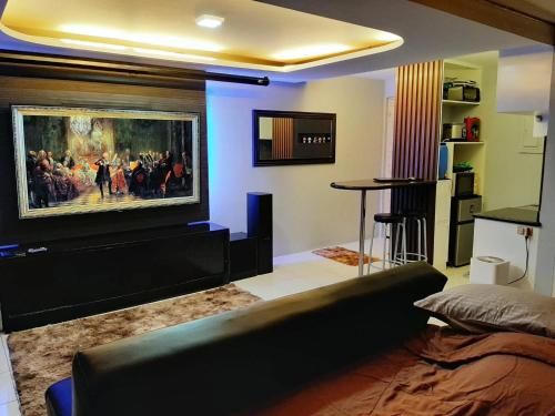 a living room with a painting on the wall at Budget Hotel in West Service in Manila