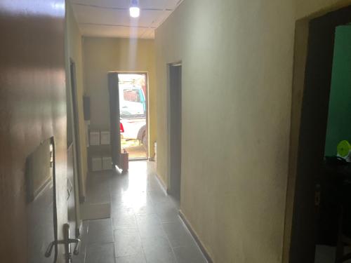 a hallway with a room with a car parked in it at Otam homes in Akure