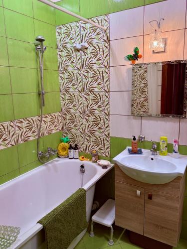 a bathroom with a tub and a sink at Old Town Riverside Antique Gallery Self Check-In in Klaipėda