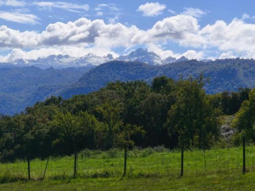 a fence in a field with mountains in the background at La Casona de Torió in Torío