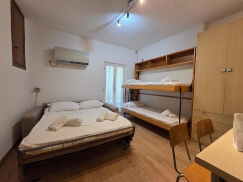 a bedroom with two bunk beds in a room at MiniMa - By Ligooria in Pietra Ligure