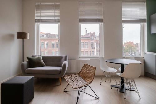 a living room with a couch chair and a table at Cosy City Apartment in Rotterdam West in Rotterdam