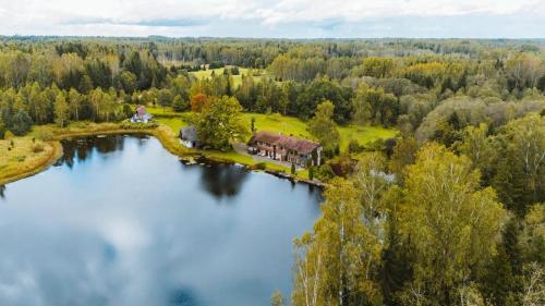 an aerial view of a house on an island in a lake at Jeiskas dzirnavas in Launkalne