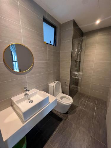a bathroom with a sink and a toilet and a mirror at Trion Residence Kuala Lumpur by Luxe in Kuala Lumpur