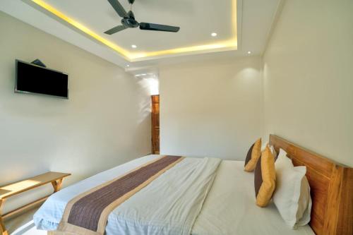 a bedroom with a bed with a ceiling fan at Castle By the Sea in Calangute
