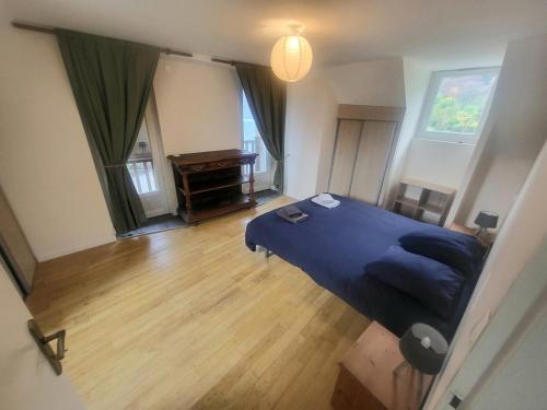 a bedroom with a blue bed and a piano at Maison des Cimes, Garden, cozy for 8 people in Ayzac-Ost