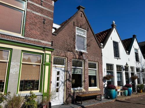 a group of houses with windows and plants at Oudegracht Alkmaar in Alkmaar