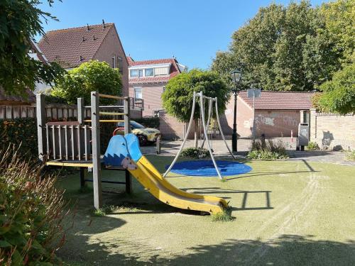 a playground with a slide in a yard at Oudegracht Alkmaar in Alkmaar
