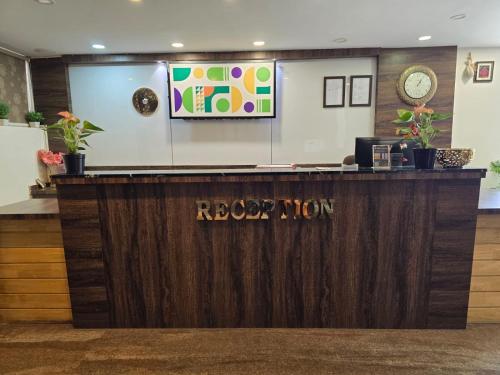 a reception desk with a sign that reads roar lion at Treebo Sai Fortune Gateway in Bengaluru