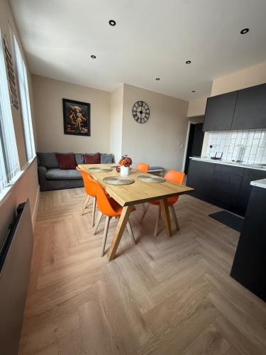 a kitchen and dining room with a table and chairs at Stylish and Bright 2 Bedroom Flat Free Parking in Wallasey