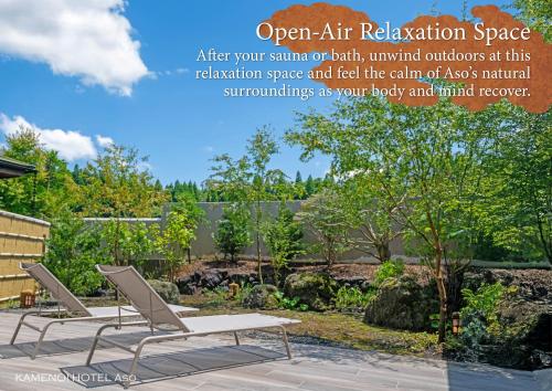 a pair of chairs and a bench in a garden at KAMENOI HOTEL Aso in Aso