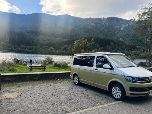 a van parked in a parking lot next to a lake at Campervan Scotland, Ben Roamer in Dunblane