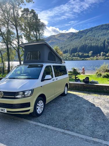 a van parked in a parking lot next to a lake at Campervan Scotland, Ben Roamer in Dunblane
