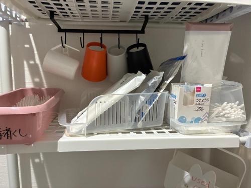 a refrigerator filled with lots of kitchen utensils at 智翔はうす 女性家主滞在民泊 5畳タイプ 予約後はメール確認願います トモカケハウス in Kumamoto