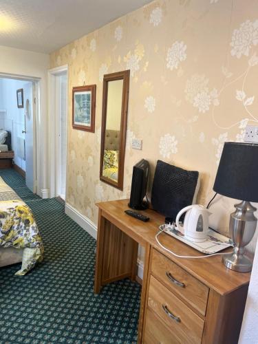 a hotel room with a desk with a computer on it at Hylands Hotel Family Room with Free Parking in Nottingham