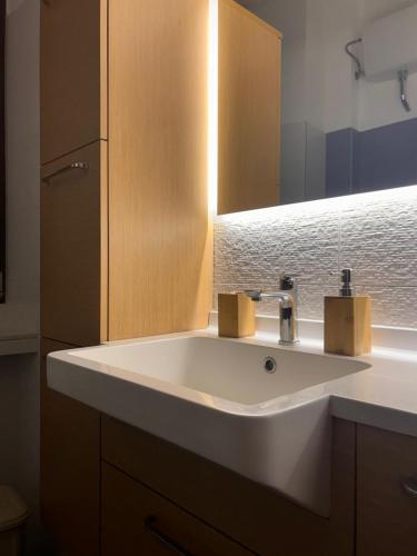 a bathroom with a white sink and a mirror at Il Palco Centrale in Tolentino