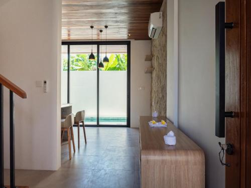 a living room with a table and a dining room at LM Home 2 Mendira in Candidasa