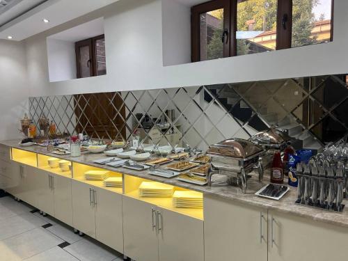 a kitchen with a counter with food on it at CITY GARDEN HOTEL in Dushanbe