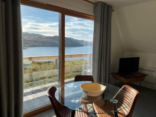 a room with a glass table and a large window at Steall Gorge - Uk50495 in Kylestrome