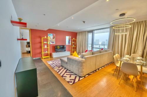 a living room with a couch and a table at Luxury Homestay Near Dubai World Trade Centre in Dubai