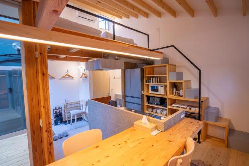a kitchen and dining room with a wooden table and chairs at Silver Daisy Stay Nikko in Nikko