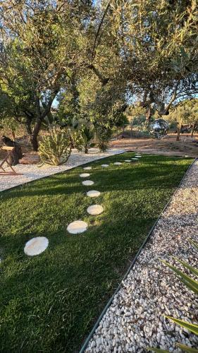 a golf course with stepping stones on the grass at Casa Luz in Guia