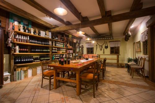 a dining room with a wooden table and chairs at Pension Kezele in Graberje Ivanićko