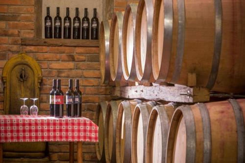 a table with bottles of wine and wine glasses at Pension Kezele in Graberje Ivanićko