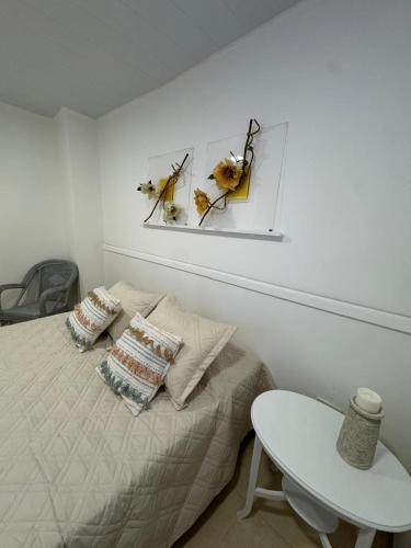 a bedroom with a bed with two pillows and a table at Don Antonio Apart 2 in Resistencia