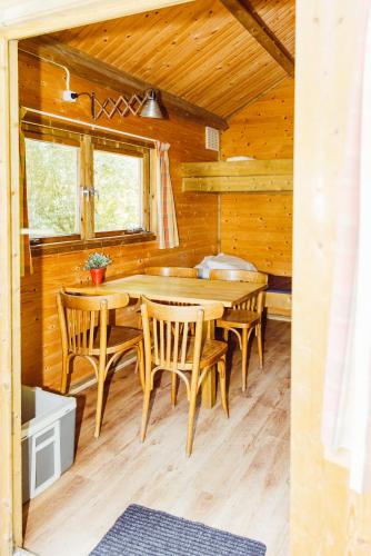 a dining room with a wooden table and chairs at Hikerscabin Trekkershut natuur in Wintger