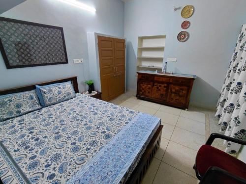 a bedroom with a bed and a dresser at CityStays by Rajat in Jaipur