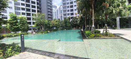 a large swimming pool in the middle of a city at Service Apartment Agile Residence KL in Kuala Lumpur