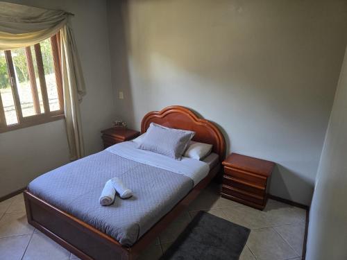 a bedroom with a bed with two towels on it at Sítio meu recanto in Paulo Lopes