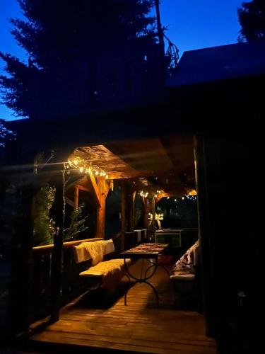 a night view of a deck with a table at Pod Magnolią in Targanice